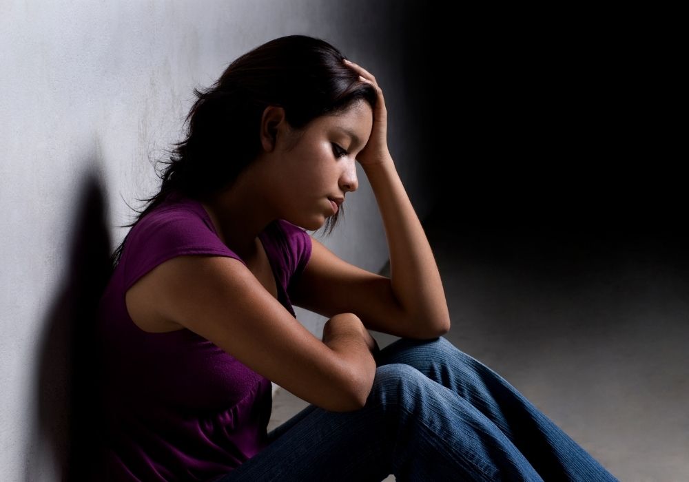 person sitting and being sad